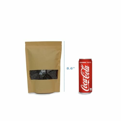 A brown coffee bag with a window next to a Coca-Cola can.