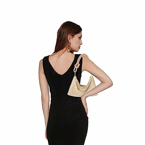 Woman in black dress with a beige handbag