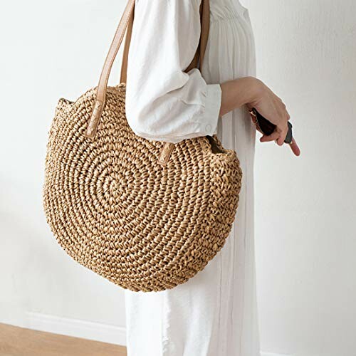 Woman holding a round woven tote bag